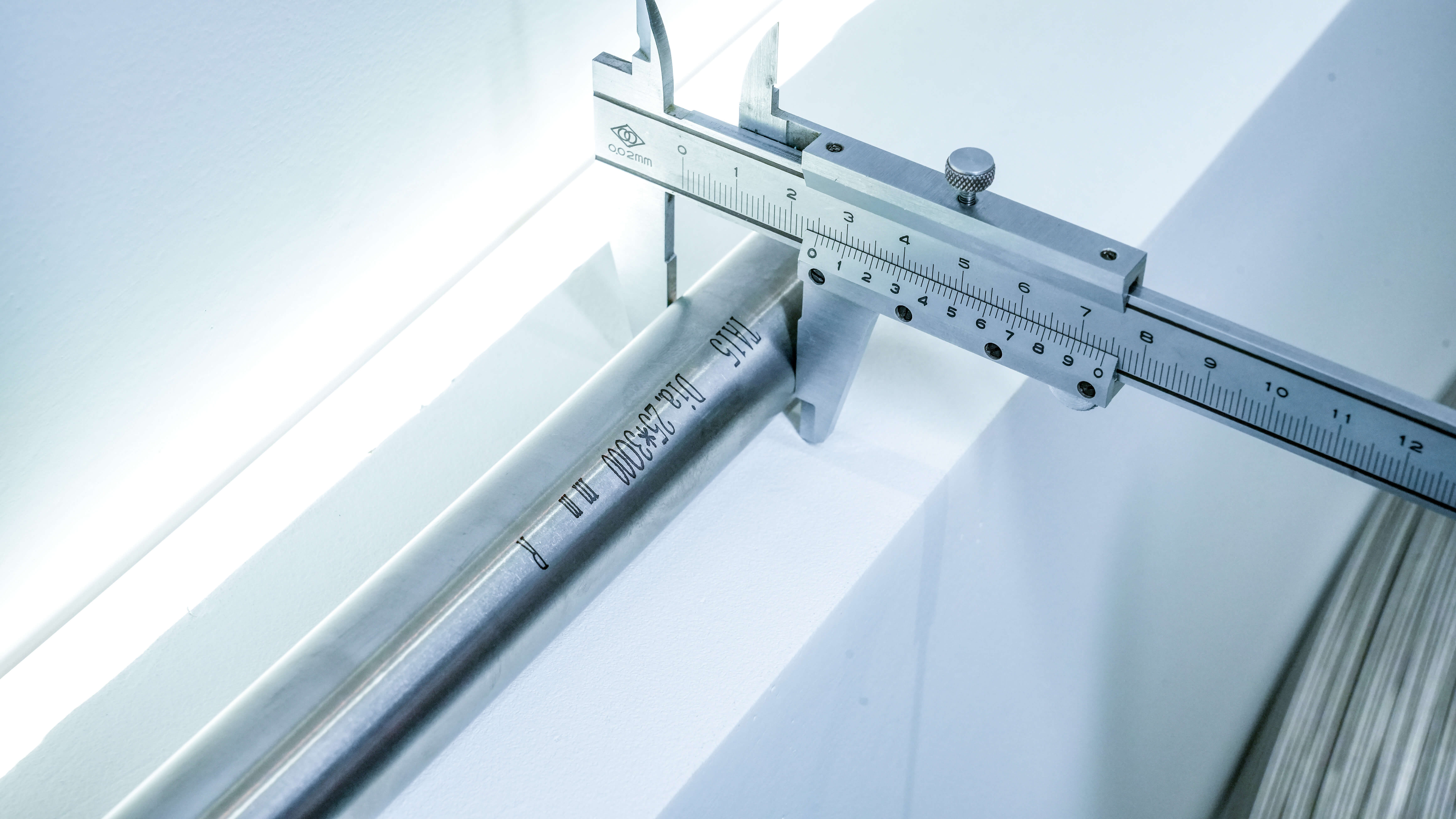 Dimensional inspection of titanium rod with a precision caliper